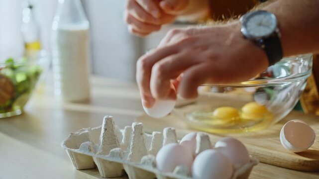 Cook hands taking eggs breaking preparing omelette standing home kitchen closeup