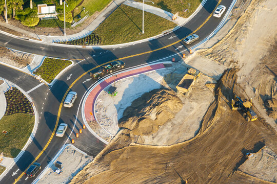 Aerial view of busy American highway road under construction. Development of roundabout traffic infrastructure. State transportation concept