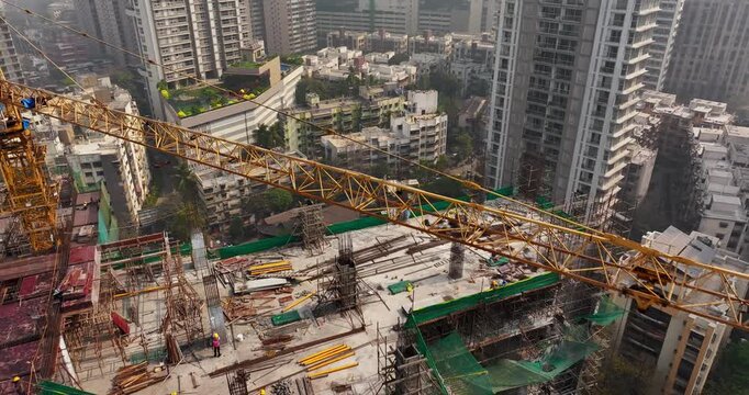 Aerial view of a building under construction in the middle of Mumbai city, India. The image captures urban development and high-rise construction activity.