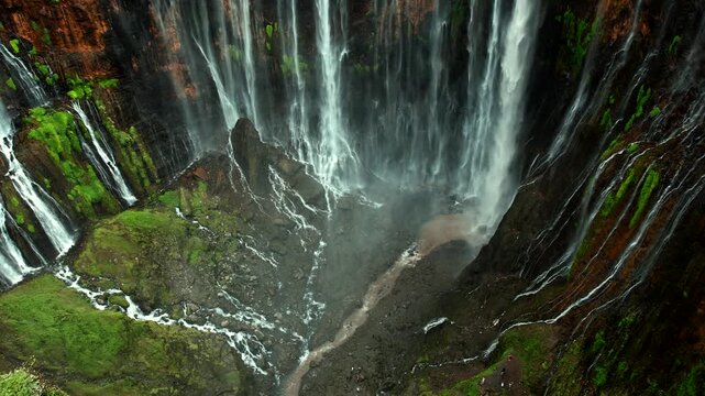 Aerial panorama of Tumpak Sewu waterfall system on Mount Semeru slopes, Java, Indonesia