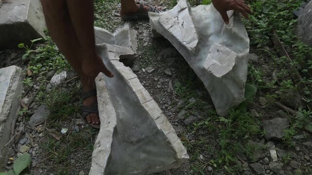 Close-up of a skilled artisan shaping a fibre sculpture using a power tool in a workshop, captured in slow motion. The scene highlights precision craftsmanship, manual labor, India
