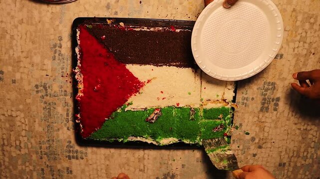 Palestinian students in diaspora celebrate a national occasion by sharing a Palestine flag cake. Close-up of hands serving colorful layers, expressing unity, identity, pride, and cultural belonging.