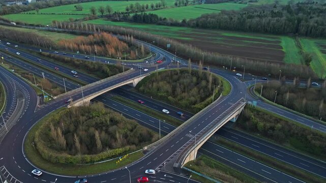 Stunning drone footage capturing evening traffic on a major road interchange along the N4 in Ireland. The smooth movement of cars contrasts beautifully with the vibrant green surroundings.