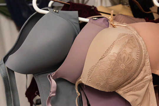 Close up shot of the different types of women push up bra hanging on the hangers. 