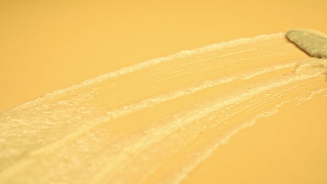 Macro Close-up of Spreading Creamy Durian Puree with Gold Spoon and Spatula on Yellow Background, Food Ads
