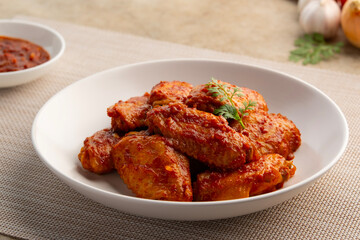 Fototapeta premium New orleans Marinated middle chicken wing on white plate.delicious sweet and spicy.