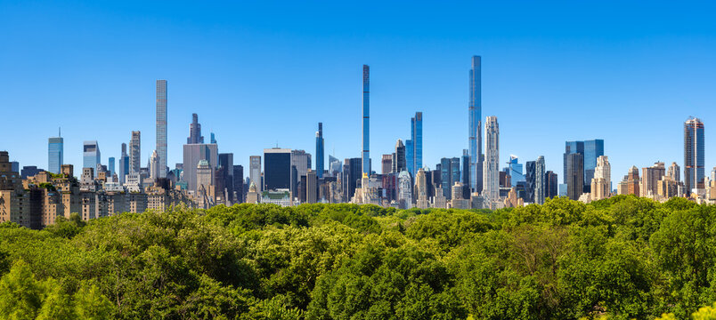New York City Billionaire's Row supertall skyscrapers overlooking trees of Central Park (elevated view). Midtown Manhattan buildings and summer greenery