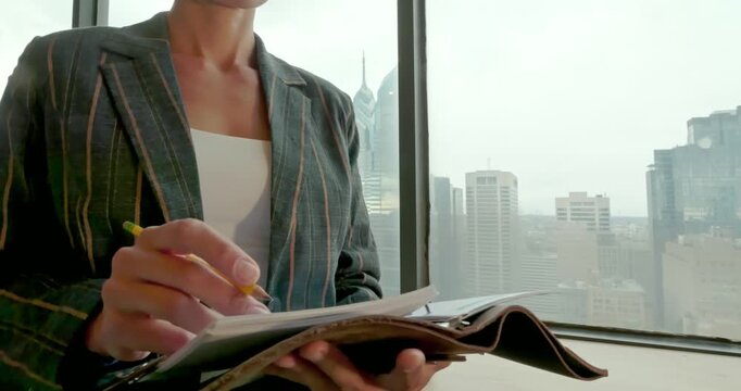 Businesswoman Writing Notes in City Office