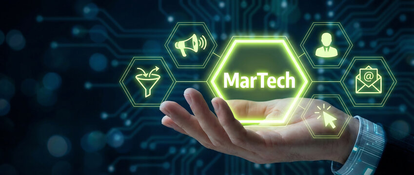 Hand holding glowing MarTech hexagon icons with digital marketing technology symbols on dark futuristic background