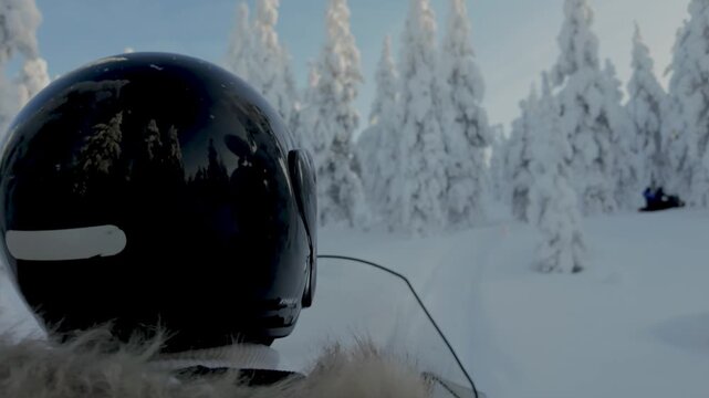 Experience the thrill of snowmobiling through the breathtaking winter landscape of Akaslompolo, Lapland Finland. Snow-covered trees create a magical white wonderland.