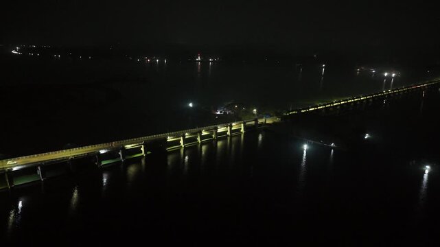 erial night view of Thanneermukkom Bund in Kerala India illuminated bridge over backwaters