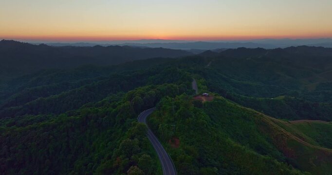 Aerial drone view of a picturesque mountain road shaped like the number three in Nan Province. This famous viewpoint attracts travelers and photographers seeking breathtaking curves and stunning