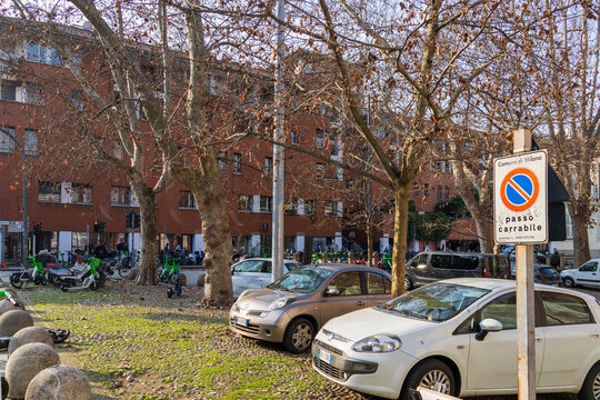 Apartments with cars and scooters on the street in Milan Italy IT