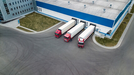 trucks are loaded in a modern logistics center © Polivan