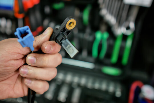 ABS sensor in the hands of an auto mechanic