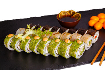 Sushi platter with green rolls nori maki and kumquat on black slate isolated © smslov