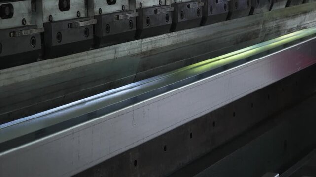 Sheet metal bending process on a hydraulic press brake. The press brake in operation, bending galvanized steel sheet with high precision.