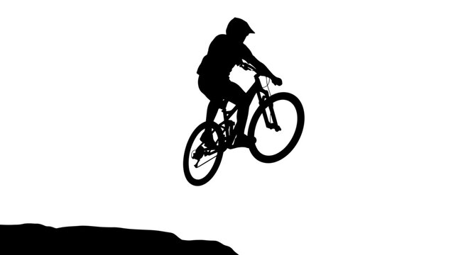 Silhouette of a Mountain Biker Jumping off a Cliff