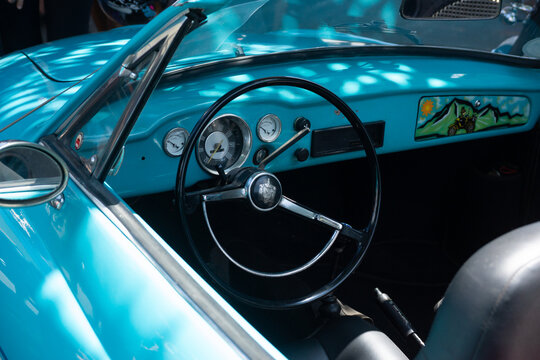 Retro Car Interior with Blue Steering Wheel
Description: Vintage car interior with blue tones highlighting steering wheel and dashboard, perfect for nostalgic visuals.