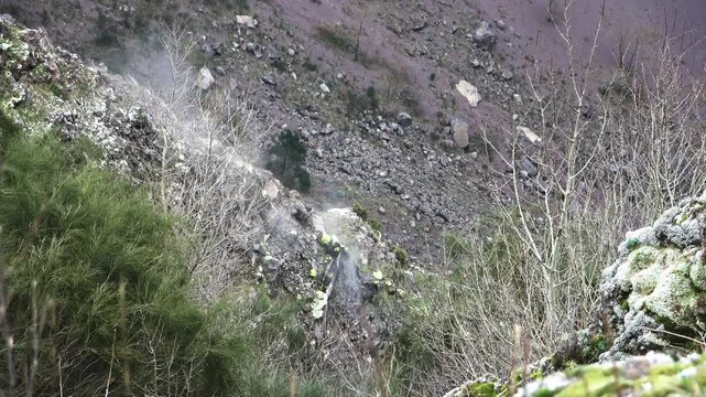 Volcanic fumaroles releasing smoke in the Vesuvius crater