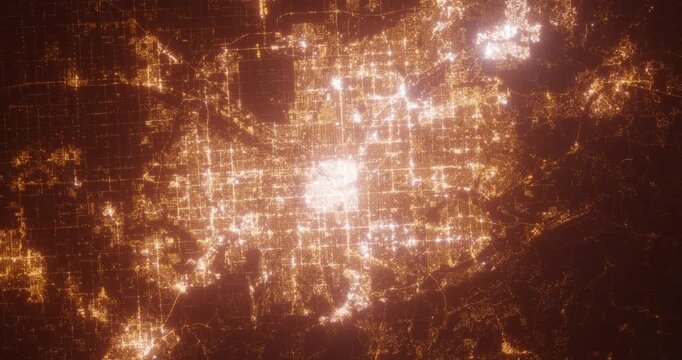 Denver (Colorado, USA) aerial view at night. Top view on modern city with street lights. Camera is zooming out, rotating counterclockwise. Vertical video. The north is on the left side