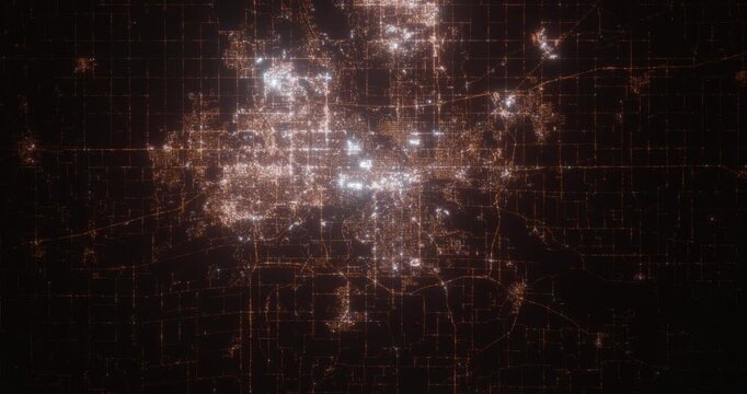 Des Moines (Iowa, USA) aerial view at night. Satellite view on modern city with street lights. Camera is flying above the city, moving forward