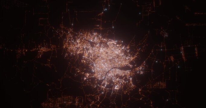 Palembang (Indonesia) aerial view at night. Top view on modern city with street lights. Camera is flying above the city, moving backward