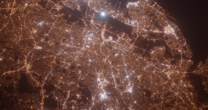 Newark (New Jersey, USA) aerial view at night. Top view on modern city with street lights. Camera is zooming out, rotating counterclockwise. Vertical video. The north is on the left side
