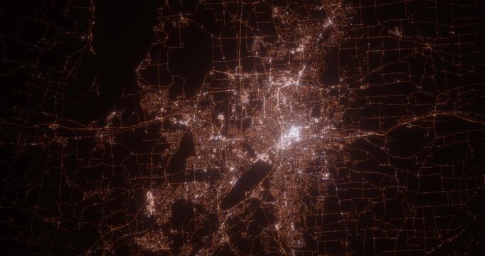 Syracuse (New York, USA) top view at night. Aerial view on modern city with lights. Camera is flying above the city, moving backward. Vertical video. The north is on the left side