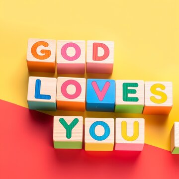 god loves you colorful blocks on yellow background