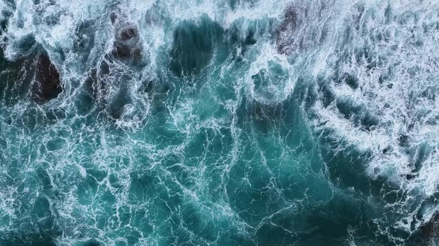 A mesmerizing drone shot taken from above, capturing the natural foam created as turquoise waves crash against the coastal rocks along Gazipaşa&rsquo;s pristine shoreline.