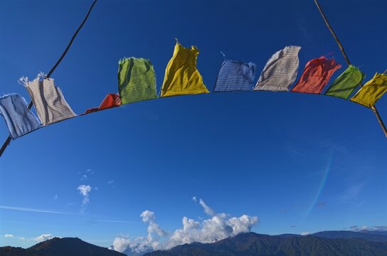 Buddhist Prayer flags fluttering in the wind with himalayas in the background