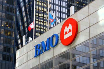 Naklejka premium Toronto, Canada - February 15, 2026: Bank of Montreal headquarters building with corporate logo and flags in Toronto downtown financial district