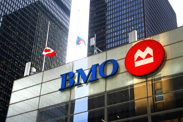 Naklejka premium Toronto, Canada - February 15, 2026: Bank of Montreal headquarters building with corporate logo and flags in Toronto downtown financial district
