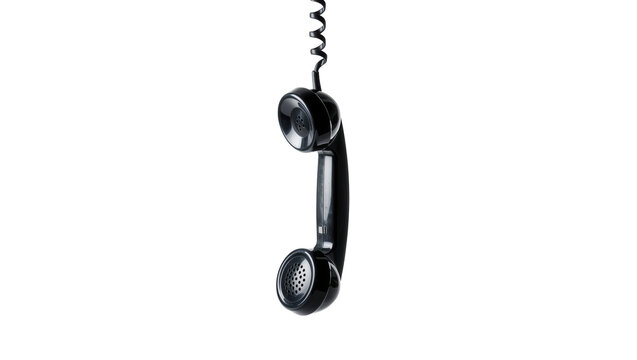 Isolated black vintage telephone receiver hanging by its coiled cord, old communication device