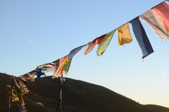 Buddhist Prayer flags fluttering in the wind with himalayas in the background