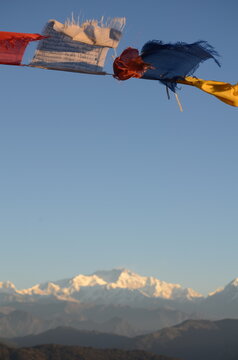 Buddhist Prayer flags fluttering in the wind with himalayas in the background