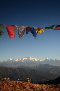 Buddhist Prayer flags fluttering in the wind with himalayas in the background