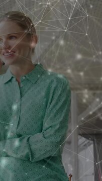 Vertical video: Woman answering incoming business call, animated nodes moving across foreground