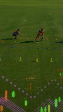 Vertical video: Low player rising and training team moving cone lanes, analytics showing numbers