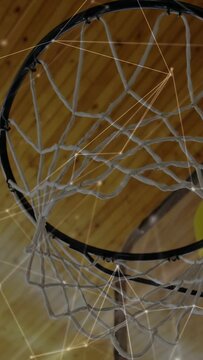 Pulling back revealing hoop with white net and clear backboard yellow-square at gym, golden overlay