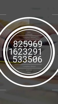 Appearing circular HUD collecting data at desk with yellow-sleeved hand tapping yellow-case phone