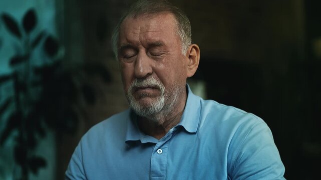 Depressed sick senior man taking medication with water, palliative treatment
