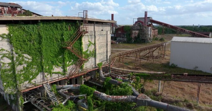 Rusty storage tanks and industrial towers of abandoned phosphate facility in Florida.