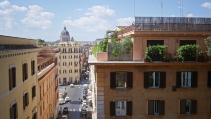 Fototapeta premium Defocused rooftop and narrow street vista with soft shallow bokeh, terraces and distant domed landmark in the city; backplate template overlay.