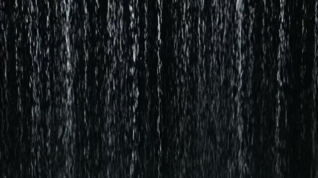 Seamless looping heavy rain water drops falling against a dark background for cinematic scenes