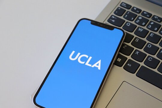 Salvador, Brazil - March 20, 2026: UCLA (University of California, Los Angeles) app logo on a smartphone screen placed over a laptop keyboard. UCLA logo. 