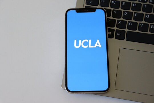 Salvador, Brazil - March 20, 2026: UCLA (University of California, Los Angeles) app logo on a smartphone screen placed over a laptop keyboard. UCLA logo. 