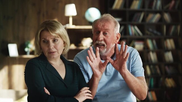 Annoyed senior man disciplining his adult daughter, generation gap, quarrel