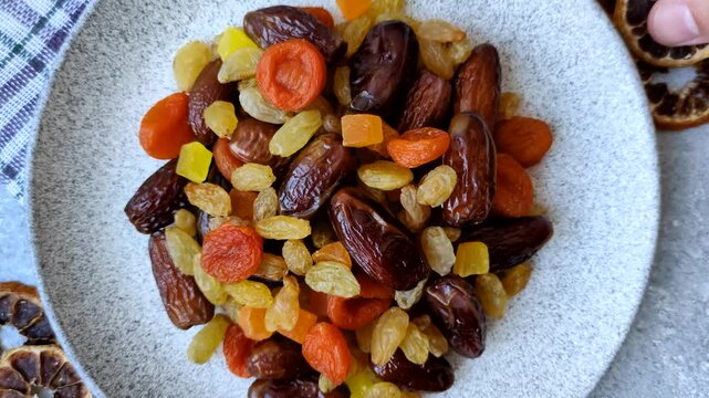Dried apricots, raisins, and candied fruits as ingredients for baked goods and sweets. Dried fruits as a food background for your design